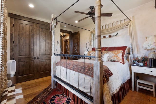 bedroom with a ceiling fan, recessed lighting, and wood finished floors