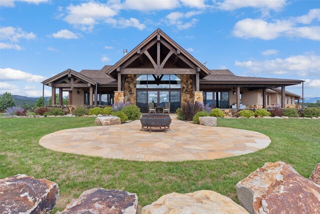 rear view of house with a patio area and a yard