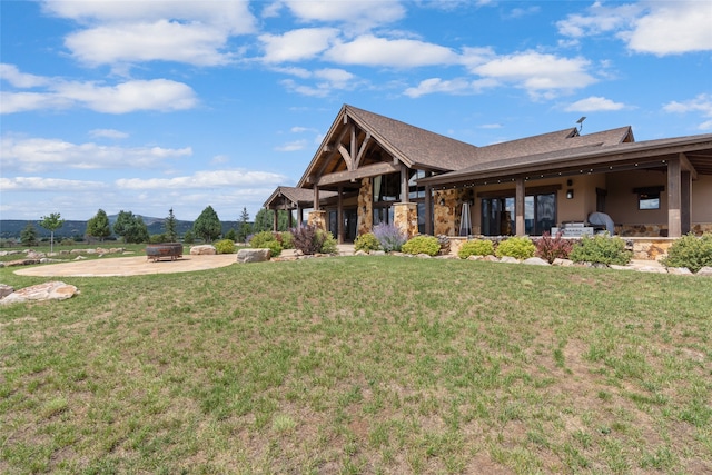 craftsman-style home featuring a patio area, a fire pit, and a front yard