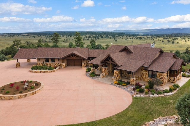 view of front of house with a rural view and a garage