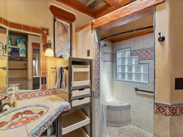 full bathroom with vanity and a tile shower