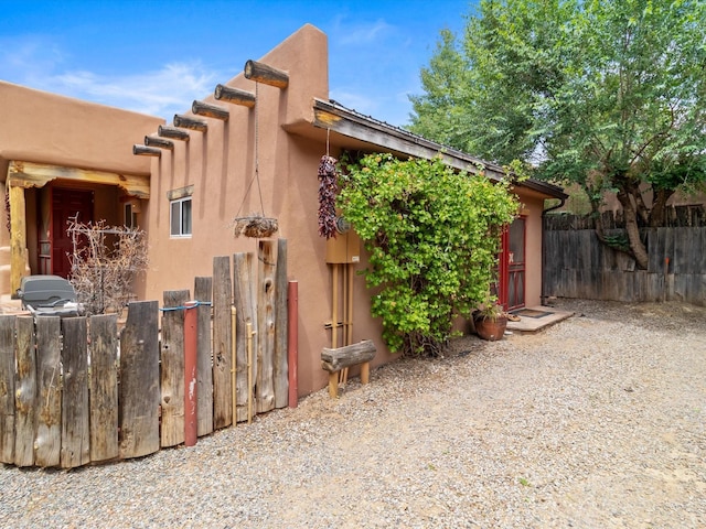 view of home's exterior with fence