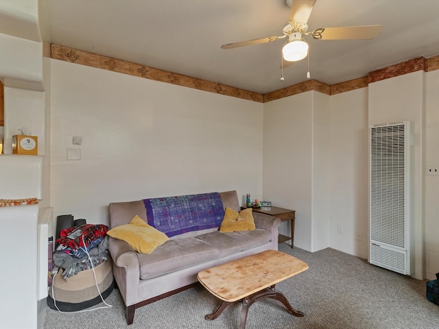 living area with carpet flooring, a heating unit, and a ceiling fan