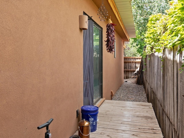 view of home's exterior featuring stucco siding and fence