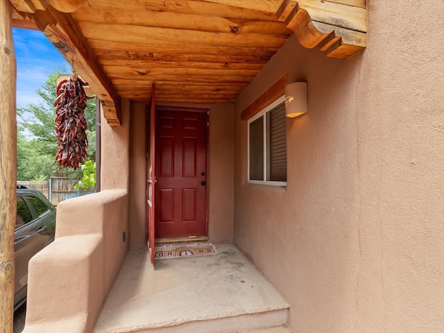 property entrance with stucco siding