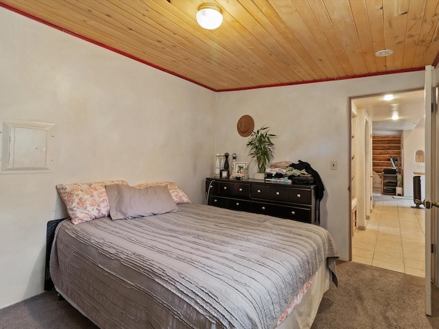 carpeted bedroom featuring tile patterned floors, wooden ceiling, electric panel, and ornamental molding