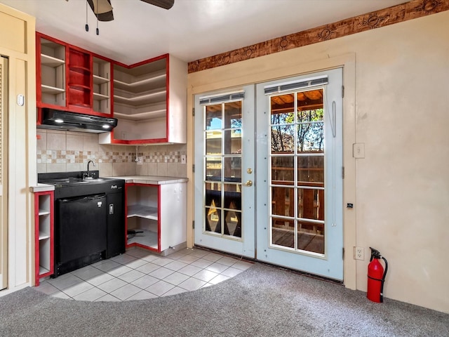 kitchen featuring tile countertops, light tile patterned flooring, ceiling fan, under cabinet range hood, and tasteful backsplash