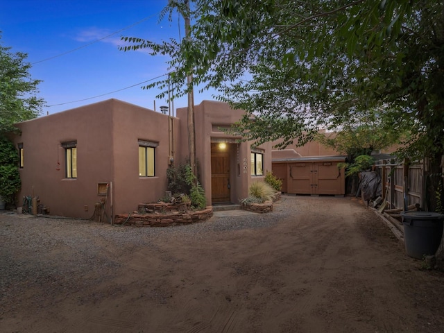 southwest-style home featuring fence