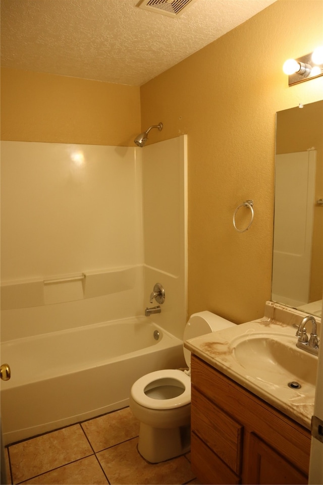 full bathroom with  shower combination, a textured ceiling, tile patterned flooring, vanity, and toilet