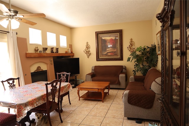 tiled living room with ceiling fan and a textured ceiling