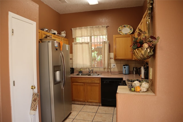 kitchen with decorative backsplash, sink, stainless steel fridge with ice dispenser, black dishwasher, and light tile patterned flooring