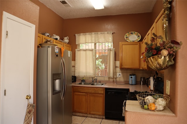 kitchen with black dishwasher, sink, light tile patterned floors, backsplash, and stainless steel fridge with ice dispenser