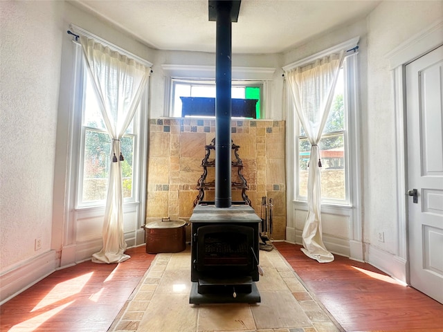 details with hardwood / wood-style floors and a wood stove