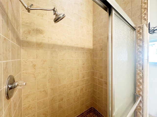 bathroom with a shower with door