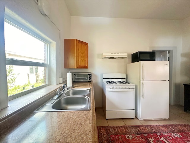 kitchen featuring sink, white appliances, and light tile patterned floors