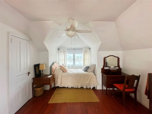 bedroom featuring hardwood / wood-style flooring, vaulted ceiling, a textured ceiling, and ceiling fan