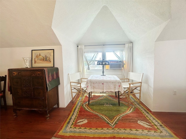 bedroom with vaulted ceiling, a textured ceiling, cooling unit, and wood-type flooring