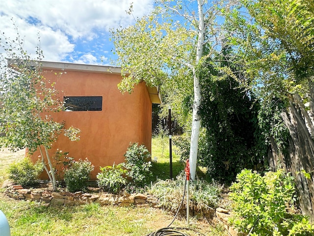 view of side of home with an outdoor structure