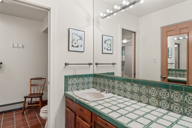 full bathroom with a baseboard heating unit, tile patterned flooring, vanity, and toilet