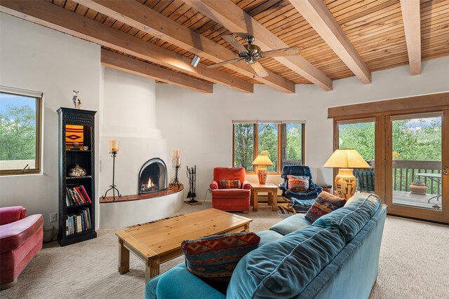 living room featuring wood ceiling, ceiling fan, beamed ceiling, and light colored carpet