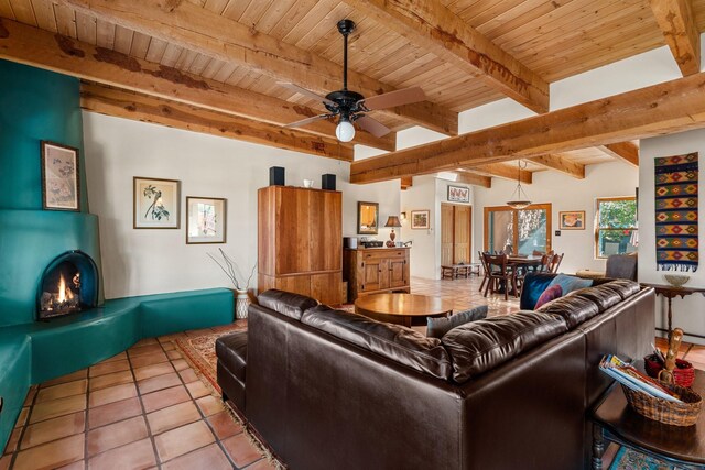 tiled living room featuring wood ceiling, ceiling fan, and beamed ceiling