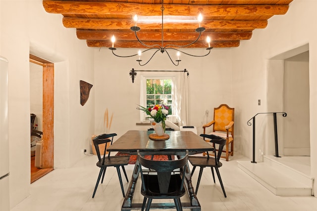 dining area featuring beam ceiling