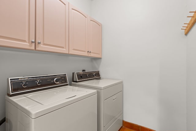 clothes washing area with cabinet space and washing machine and clothes dryer