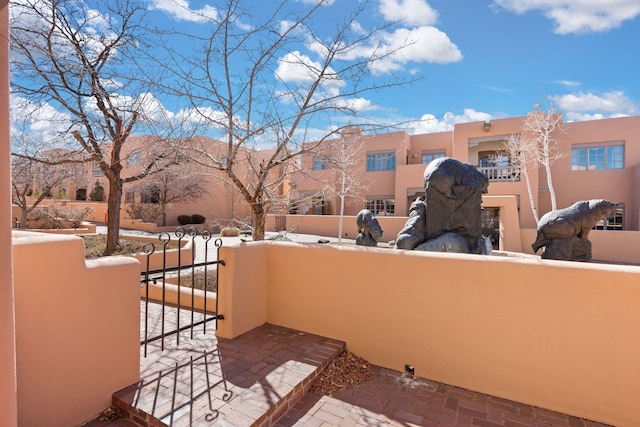 view of patio / terrace featuring a fenced front yard and a gate