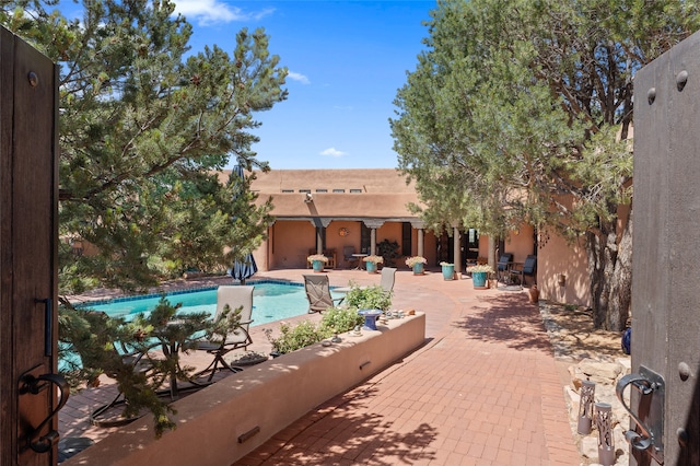 outdoor pool featuring a patio