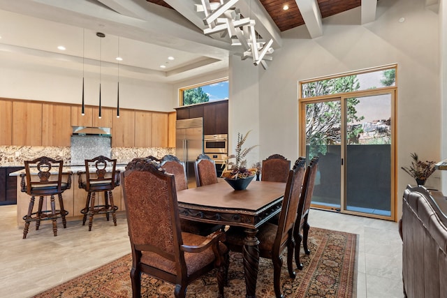 dining space with wood ceiling and a towering ceiling