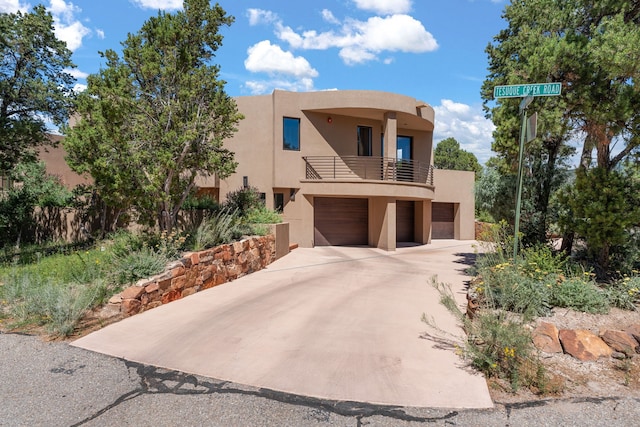 view of front of home with a balcony and a garage