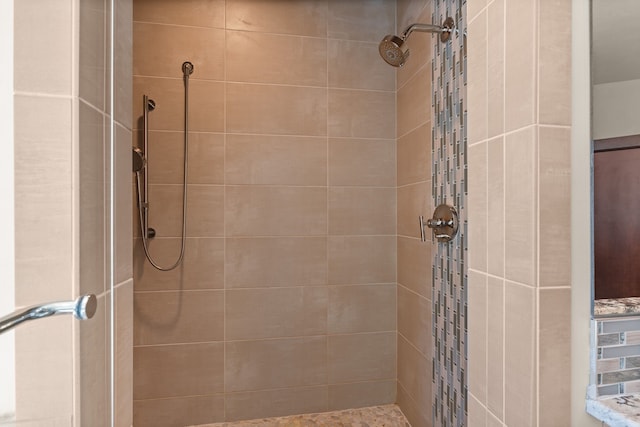 bathroom with tiled shower