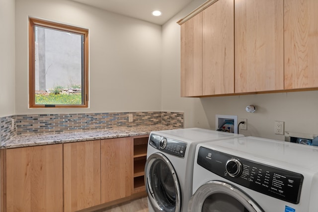 laundry area featuring cabinets and washer and clothes dryer