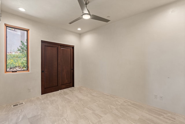 unfurnished bedroom with light colored carpet and ceiling fan