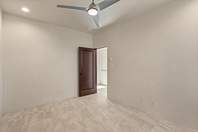 empty room featuring ceiling fan and light colored carpet