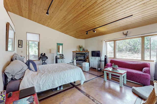 bedroom featuring rail lighting, wooden ceiling, lofted ceiling, and concrete flooring