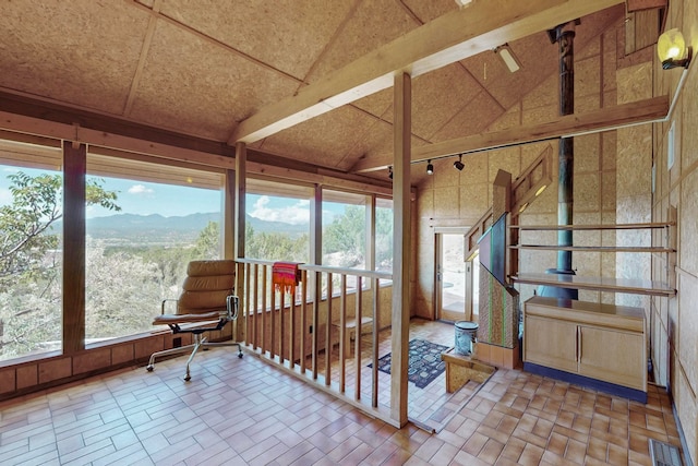 sunroom featuring a mountain view and vaulted ceiling