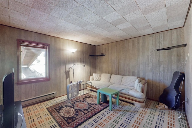 living room featuring wood walls and a baseboard radiator