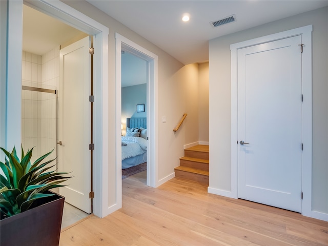 hallway with light hardwood / wood-style floors