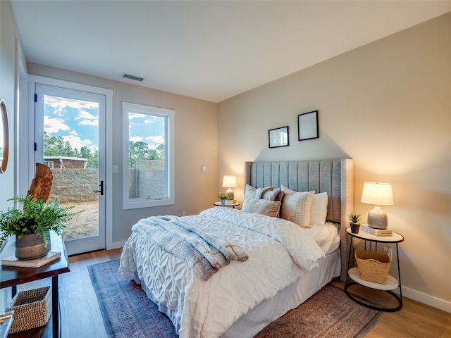 bedroom with light hardwood / wood-style floors and access to outside