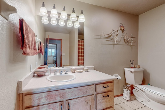 bathroom with toilet, tile patterned flooring, and vanity