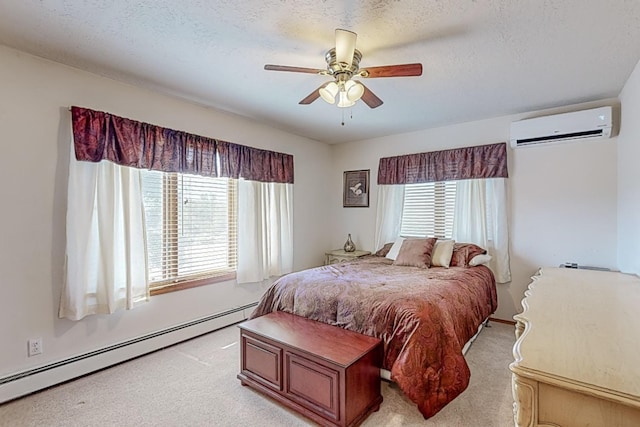 bedroom with a textured ceiling, light carpet, a ceiling fan, a wall mounted AC, and baseboard heating