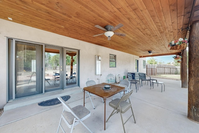 view of patio / terrace featuring fence, french doors, a ceiling fan, and outdoor dining space