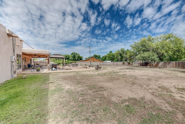 view of yard featuring a fenced backyard, a patio, and a gazebo