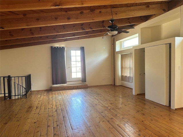 spare room featuring light hardwood / wood-style flooring, ceiling fan, and vaulted ceiling with beams