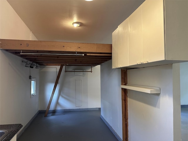 interior space with concrete floors and baseboards