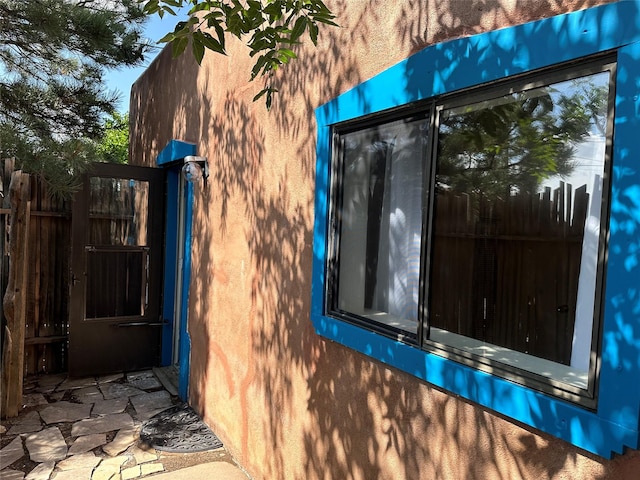 view of property exterior with fence and stucco siding