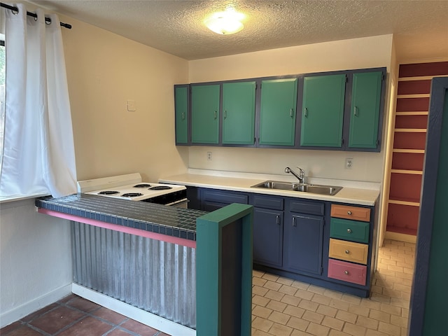 kitchen featuring a textured ceiling, tile patterned flooring, kitchen peninsula, sink, and white range with electric stovetop