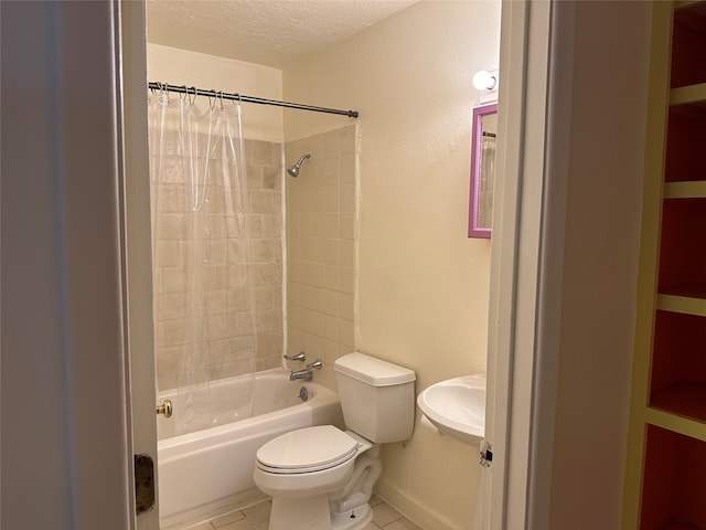 full bathroom with toilet, tile patterned flooring, a textured ceiling, sink, and shower / tub combo with curtain