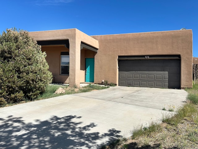 pueblo-style house with a garage